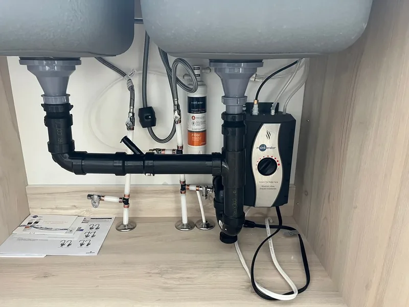 Tidy under-sink plumbing with an instant hot water tank, water filter, and PEX supply lines